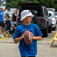 Attendee prepares to throw football during Family Day tailgate.